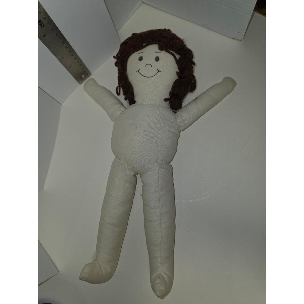 handmade or kit-based muslin cloth rag doll‎ featuring brown yarn hair